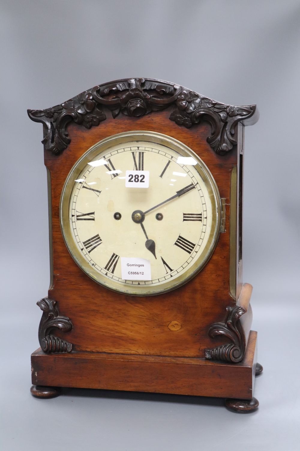 A Regency mahogany eight day bracket clock, with a carved domed top, height 45cm